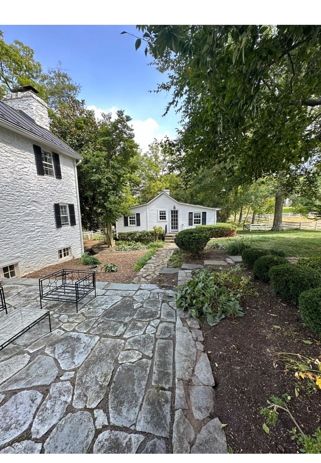 Irregular flagstone patio and path among garden beds